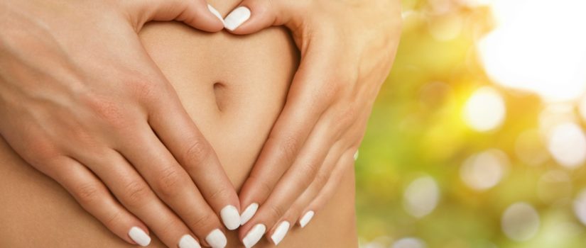 Want to Lose Weight? Take Care of your Gut Body care, pregnancy or diet concept, female hands forming heart shape on the stomach