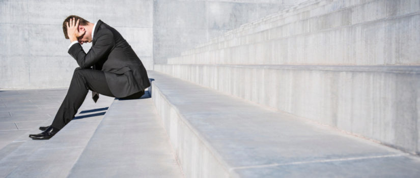 If you are not Failing, you are not Trying Hard Enough Businessman sitting on concrete steps with head in hands